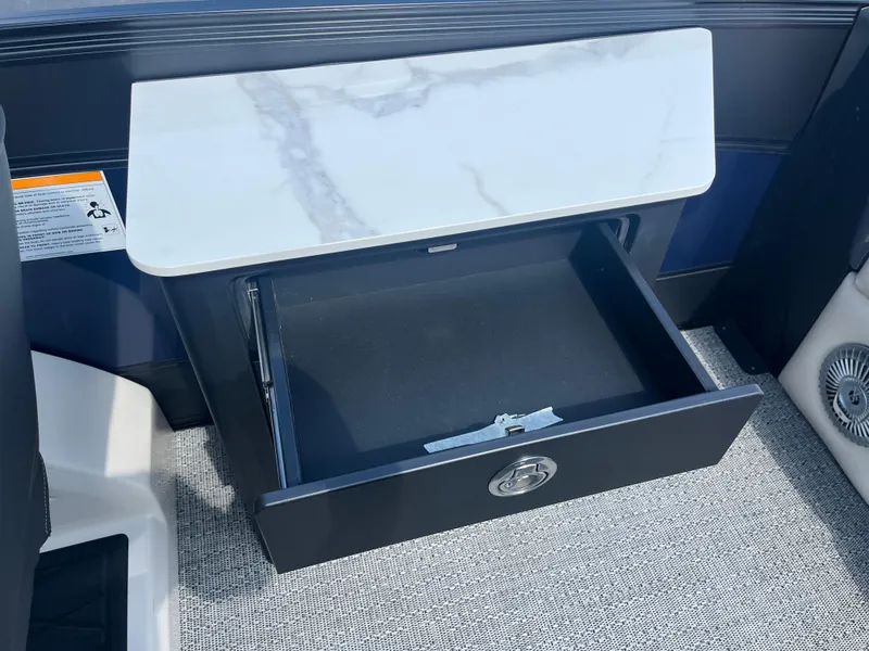 Slide: The Image of Open storage compartment in 2025 Barletta L25UEA boat with marble-like countertop. - 22