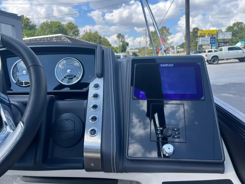 Slide: The Image of 2025 Barletta L25UEA boat dashboard with Simrad display and gauges. - 26