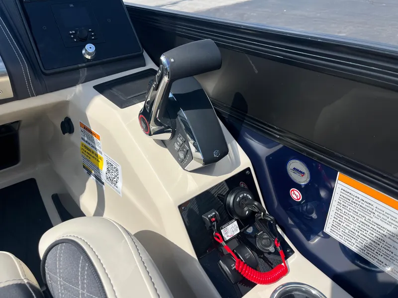 Slide: The Image of 2025 Barletta L25UEA boat control panel with throttle and safety features. - 27