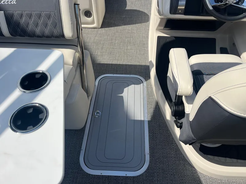 Slide: The Image of 2025 Barletta L25UEA boat interior with seating and cup holders. - 29