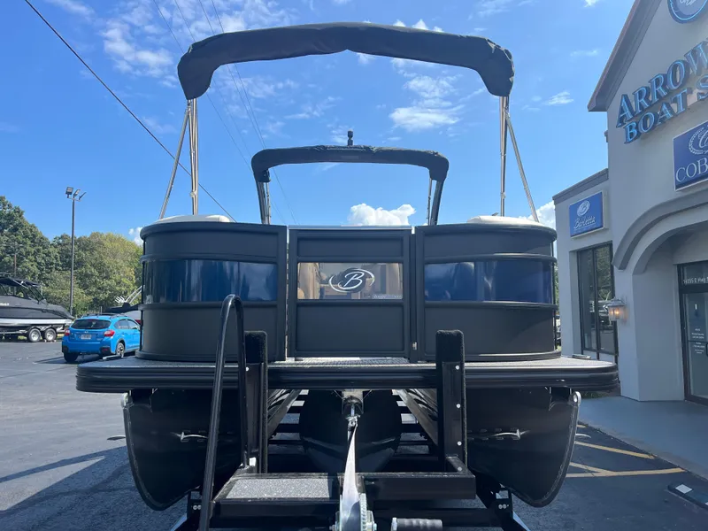 Slide: The Image of 2025 Barletta L25UEA pontoon boat at dealership, sunny day. - 3