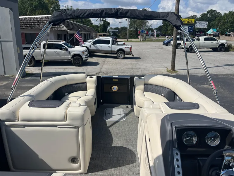 Slide: The Image of 2025 Barletta L25UEA pontoon boat interior with plush seating and dashboard. - 31