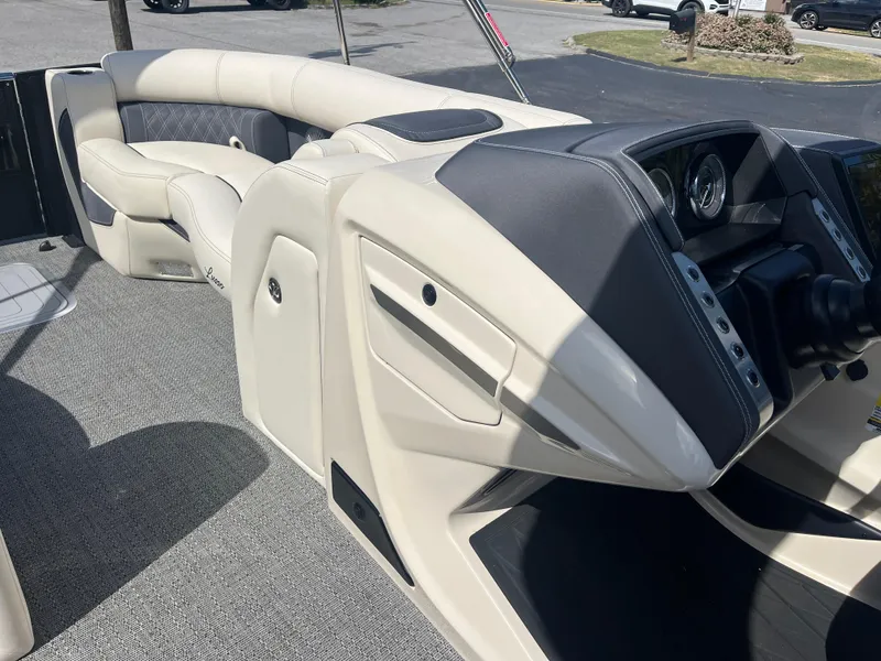 Slide: The Image of 2025 Barletta L25UEA boat interior with luxurious seating and modern dashboard. - 32