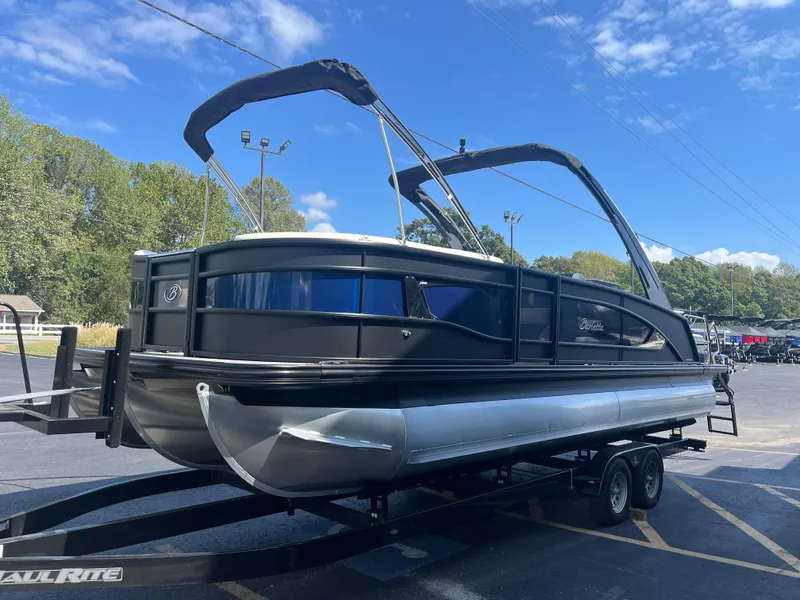Slide: The Image of 2025 Barletta L25UEA pontoon boat on trailer under blue sky. - 4