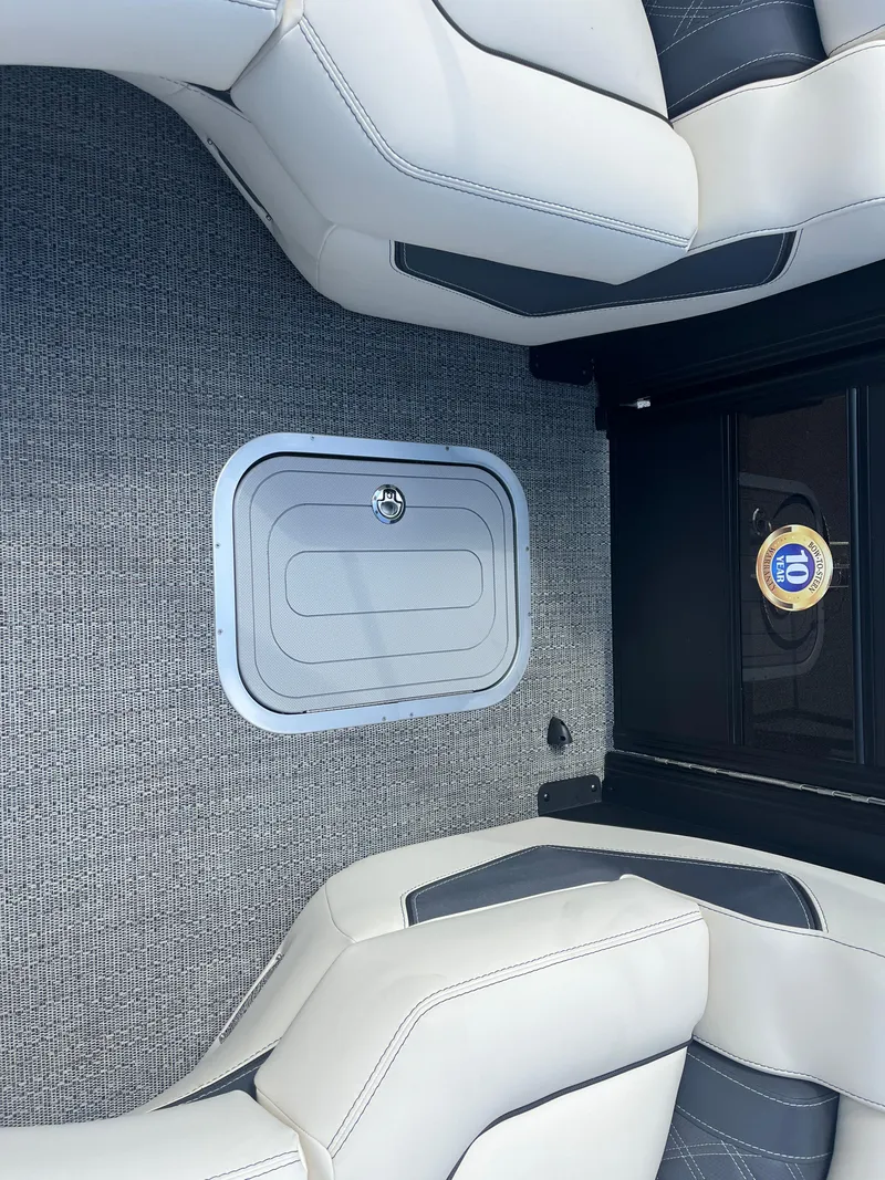 Slide: The Image of 2025 Barletta L25UEA boat interior with white seating and storage compartment. - 40