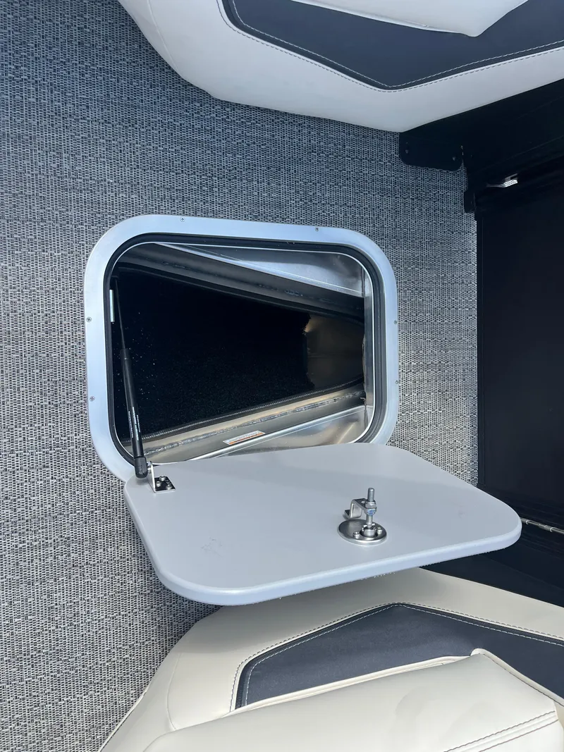 Slide: The Image of Barletta L25UEA 2025 boat storage compartment with open hatch and latch. - 41