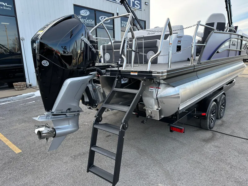 Slide: The Image of 2024 Barletta X23UC pontoon boat with Mercury outboard motor, displayed on a trailer. - 12