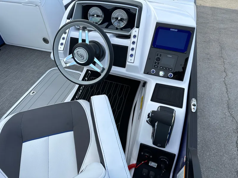 Slide: The Image of 2024 Barletta X23UC boat dashboard with steering wheel and control panel. - 17