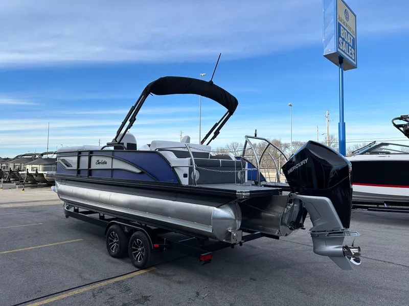 Slide: The Image of 2024 Barletta X23UC pontoon boat with Mercury engine on trailer at dealership. - 5