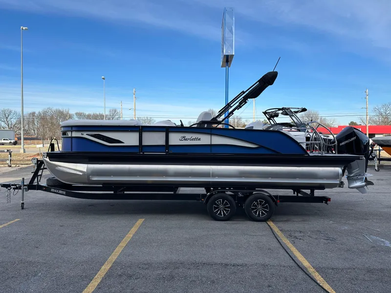 Slide: The Image of 2024 Barletta X23UC pontoon boat on trailer in parking lot. - 6