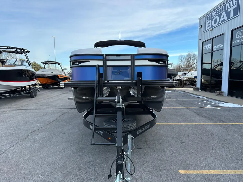 Slide: The Image of 2024 Barletta X23UC pontoon boat on trailer in dealership lot. - 8