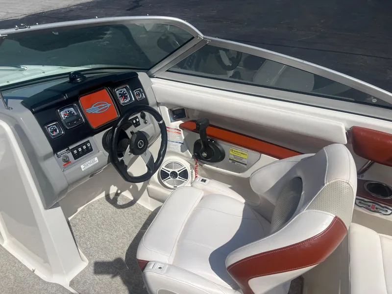 Slide: The Image of 2010 Chaparral 226 boat interior with steering wheel and dashboard controls. - 14