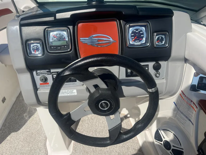 Slide: The Image of 2010 Chaparral 226 boat dashboard with steering wheel and gauges. - 15