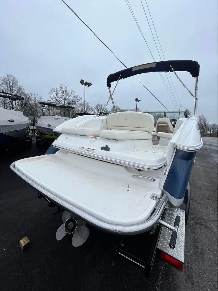 Slide: The Image of 2007 Cobalt 232 boat with swim platform and canopy, parked outdoors. - 2