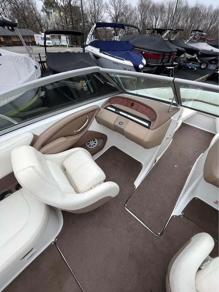 Slide: The Image of Interior of a 2007 Cobalt 232 boat with white and beige seating. - 6