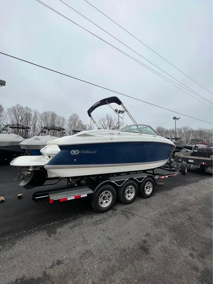 Slide: The Image of 2007 Cobalt 232 boat on trailer, parked outdoors, overcast sky. - 9