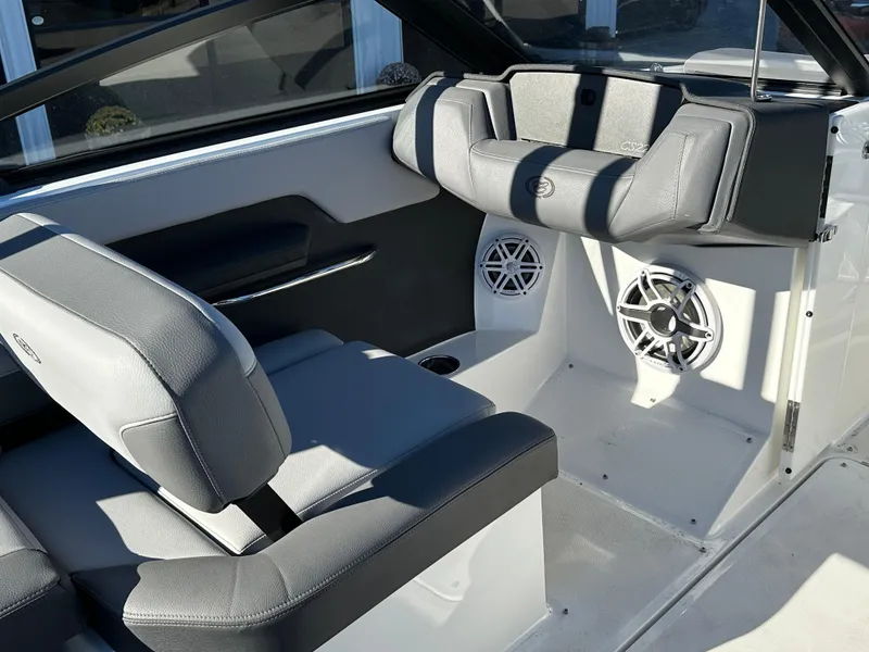 Slide: The Image of 2024 Cobalt CS22 boat interior with gray seating and built-in speakers. - 13
