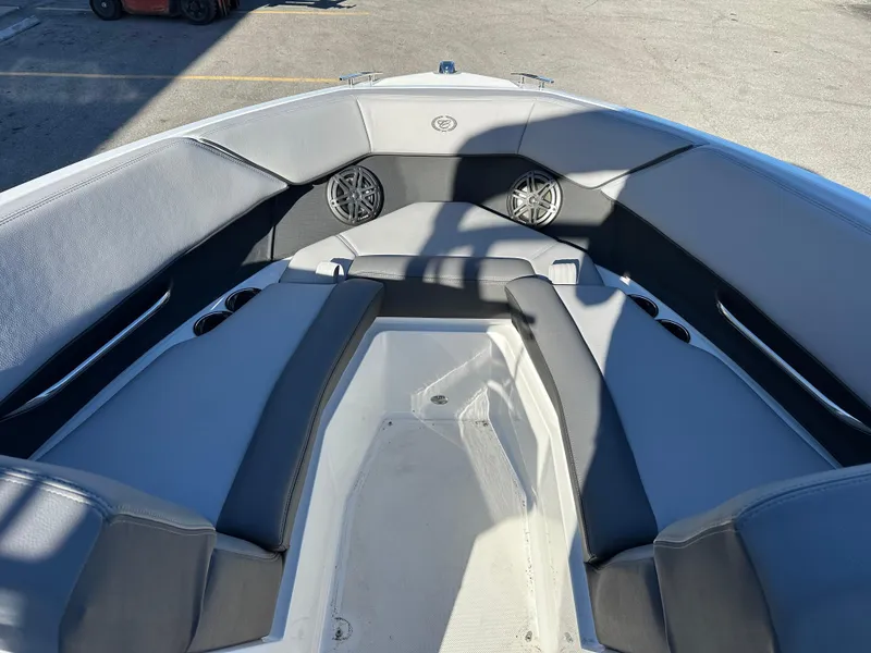 Slide: The Image of 2024 Cobalt CS22 boat interior with gray seating and speakers. - 15