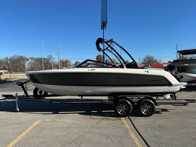 Slide: The Image of 2024 Cobalt CS22 boat on trailer, parked outdoors under clear blue sky. - 5