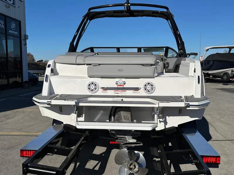 Slide: The Image of 2024 Cobalt CS22 boat on trailer, rear view with speakers and propeller visible. - 7