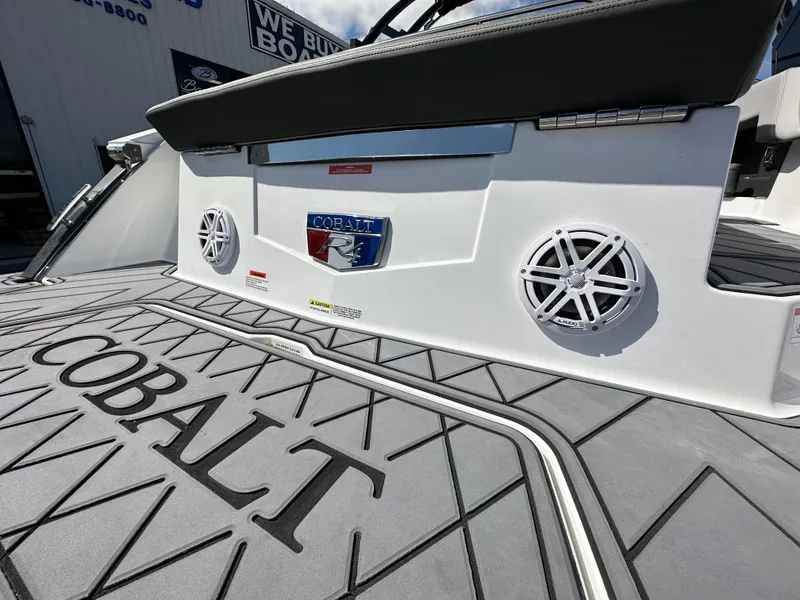 Slide: The Image of 2023 Cobalt R4 boat with branded deck and speakers, showcasing luxury design. - 11