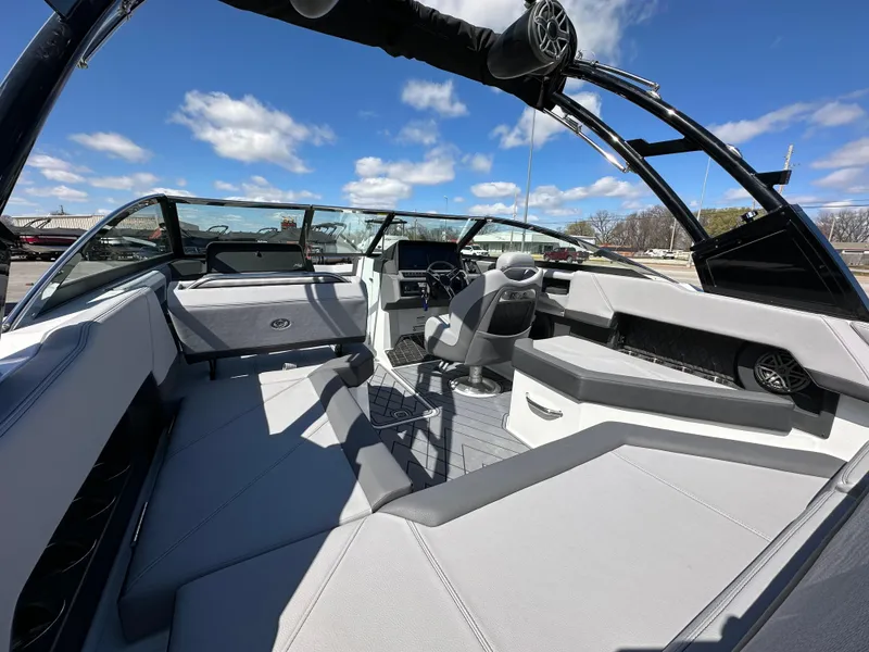 Slide: The Image of 2023 Cobalt R4 boat interior with modern seating and sleek design under a blue sky. - 14