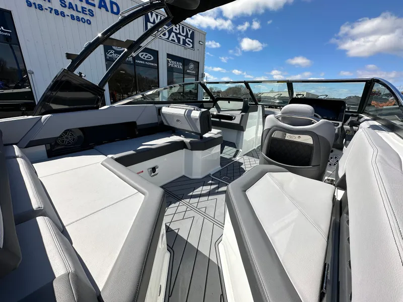 Slide: The Image of 2023 Cobalt R4 boat interior with luxurious seating and modern design under a clear blue sky. - 15