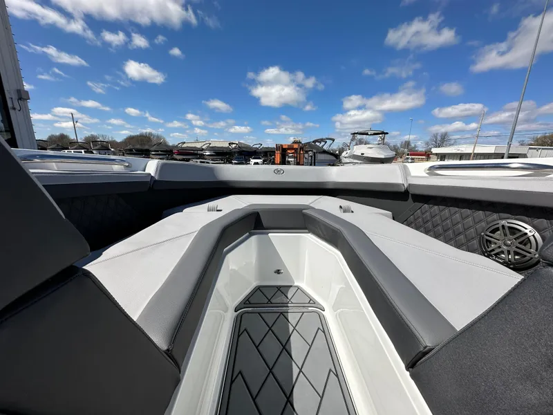 Slide: The Image of 2023 Cobalt R4 boat interior with sleek seating and modern design under blue sky. - 19