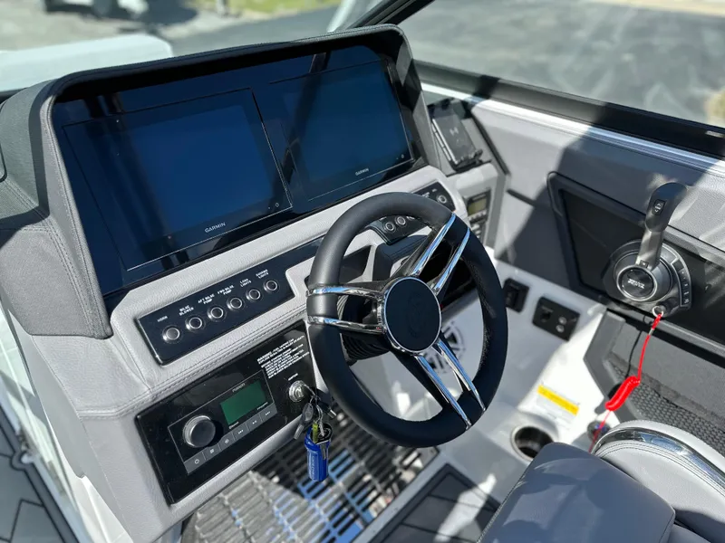 Slide: The Image of 2023 Cobalt R4 boat dashboard with steering wheel and digital displays. - 21