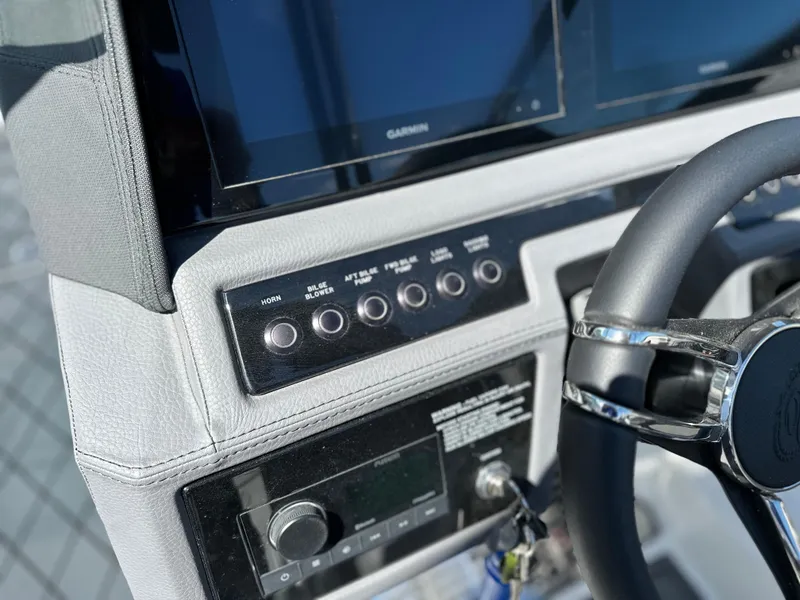 Slide: The Image of 2023 Cobalt R4 boat dashboard with steering wheel and control panel. - 22