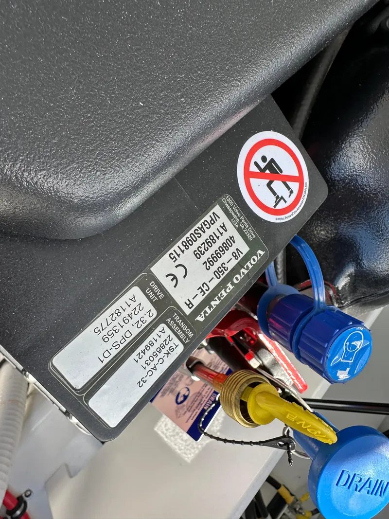 Slide: The Image of Close-up of a 2023 Cobalt R4 engine component with warning label and blue caps. - 33