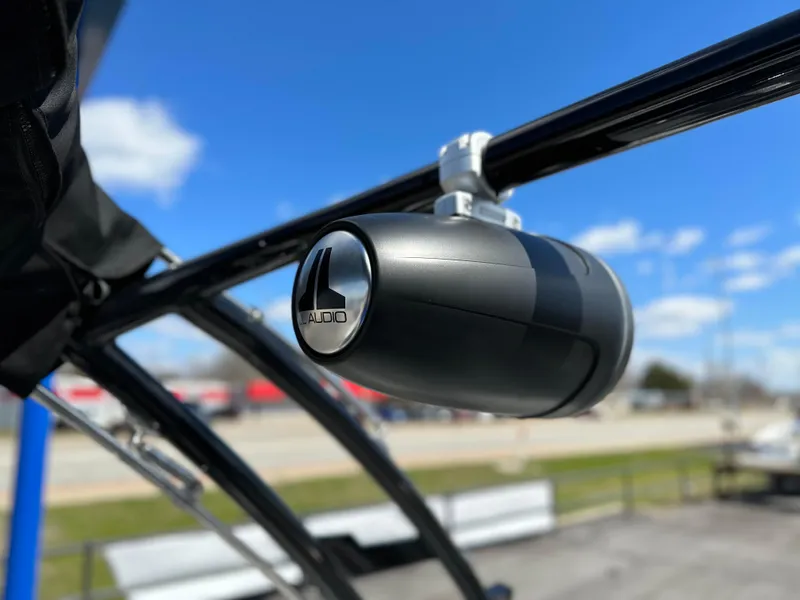 Slide: The Image of JL Audio speaker on 2023 Cobalt R4 boat against blue sky. - 35