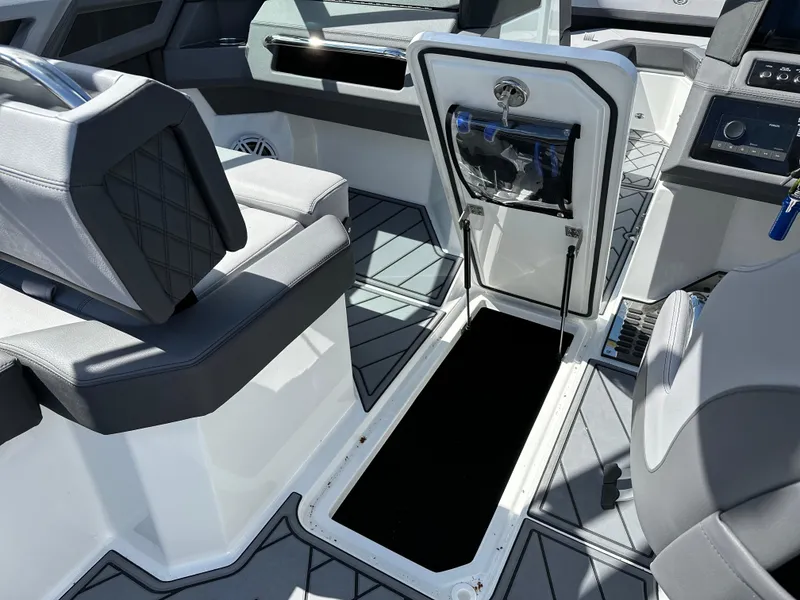 Slide: The Image of 2023 Cobalt R4 boat interior with open storage compartment and modern seating. - 39