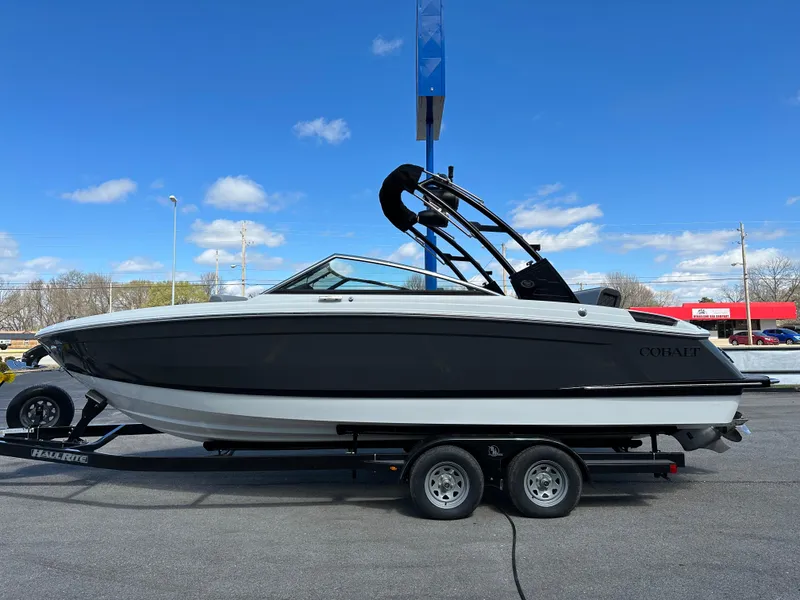 Slide: The Image of 2023 Cobalt R4 boat on trailer under clear blue sky. - 7