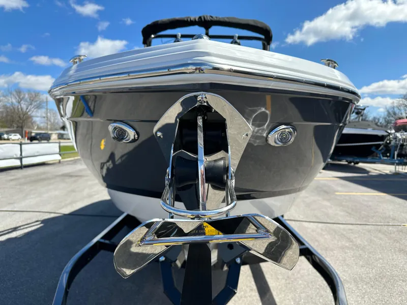 Slide: The Image of 2023 Cobalt R4 boat front view with chrome details under a blue sky. - 9