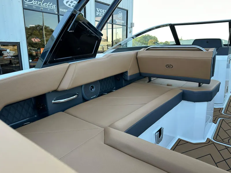 Slide: The Image of 2024 Cobalt R6 boat interior with tan leather seating and modern design. - 12