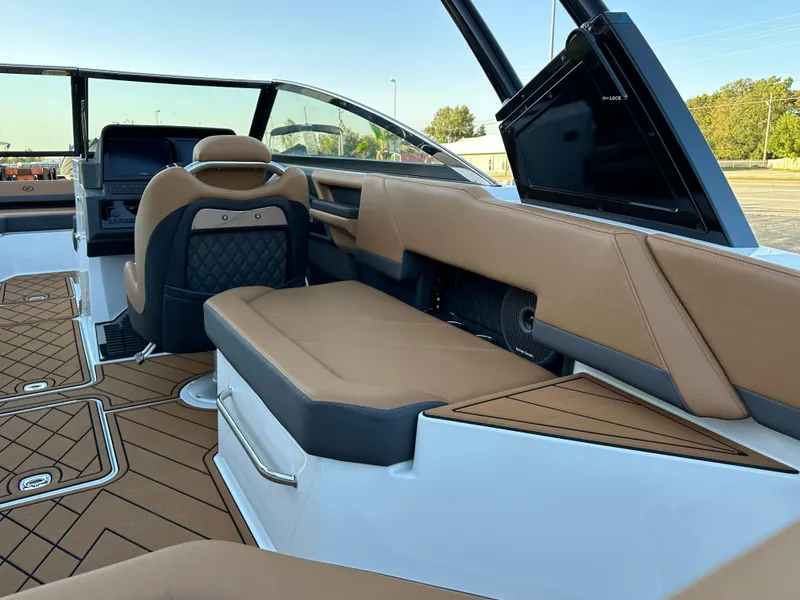 Slide: The Image of 2024 Cobalt R6 boat interior with tan leather seating and modern dashboard. - 13