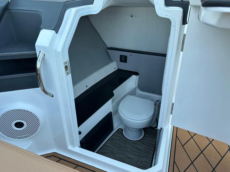 Slide: The Image of 2024 Cobalt R6 boat interior with compact bathroom and modern design. - 18
