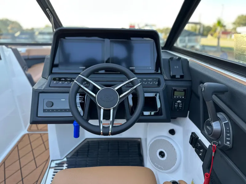 Slide: The Image of 2024 Cobalt R6 boat dashboard with steering wheel and control panel. - 20