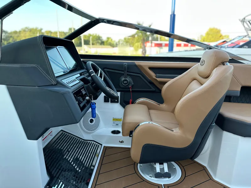 Slide: The Image of 2024 Cobalt R6 boat interior with tan leather seating and modern dashboard. - 21