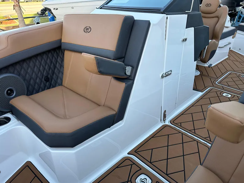 Slide: The Image of 2024 Cobalt R6 boat interior with tan leather seating and diamond-patterned flooring. - 23