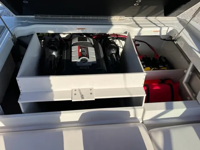 Slide: The Image of 2018 Cownline 225ss boat engine compartment with visible engine and storage. - 11