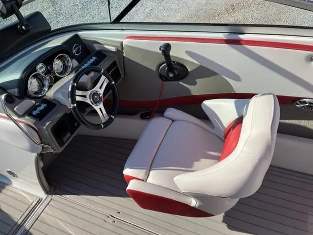 Slide: The Image of 2018 Cownline 225ss boat interior with steering wheel and captain's seat. - 4