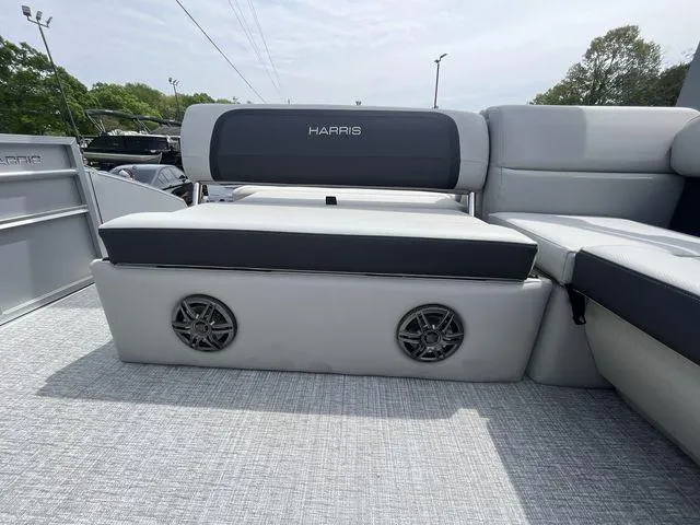 Slide: The Image of 2024 Harris 230CX boat interior with gray seating and built-in speakers. - 11