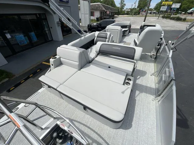 Slide: The Image of 2024 Harris 230CX pontoon boat with spacious seating and modern design. - 12