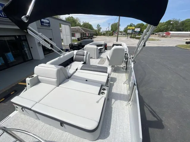 Slide: The Image of 2024 Harris 230CX pontoon boat with spacious seating and modern design. - 15