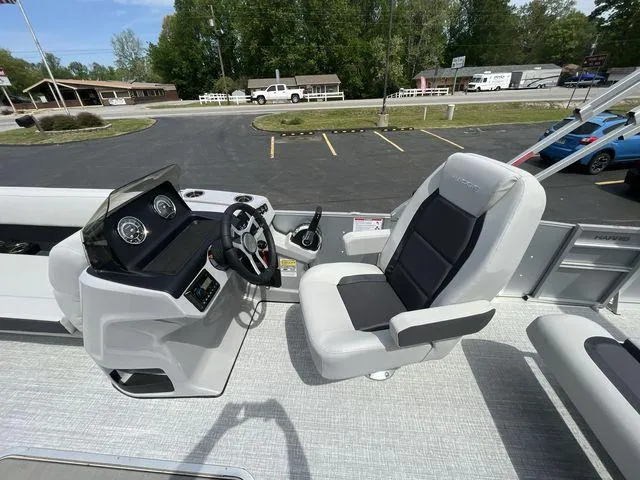 Slide: The Image of 2024 Harris 230CX boat interior with steering console and captain's chair. - 17