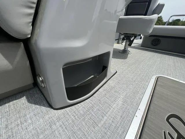 Slide: The Image of 2024 Harris 230CX boat interior with gray seating and flooring. - 18