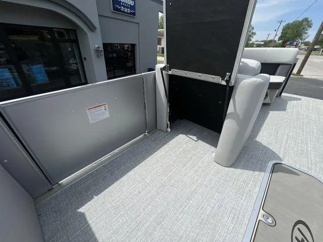 Slide: The Image of 2024 Harris 230CX boat interior with gray flooring and seating. - 20