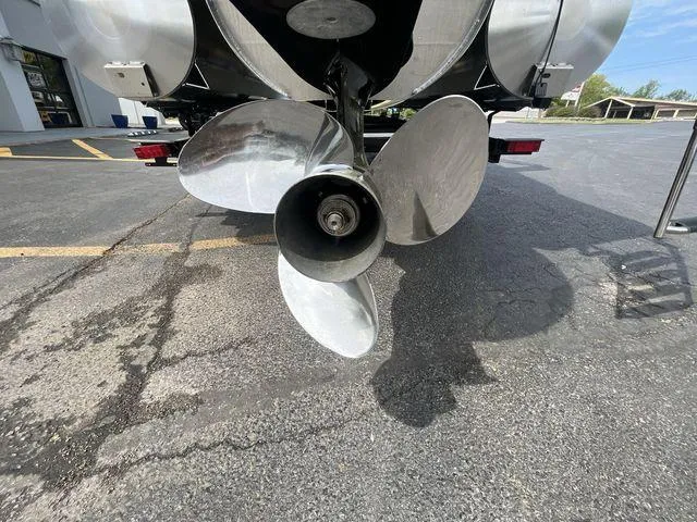 Slide: The Image of Close-up of a 2024 Harris 230CX boat propeller on pavement. - 24